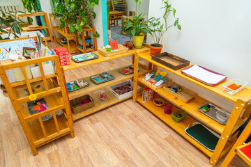 Corner of a classroom with different shelves holding learning tools