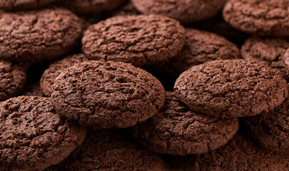 Chocolate brownie cookies with cracks placed throughout the screen selective focus. Food background.