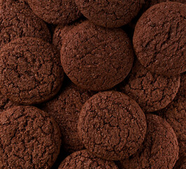 Chocolate brownie cookies with cracks background, Chocolate cookies round shape taken from above, close up.