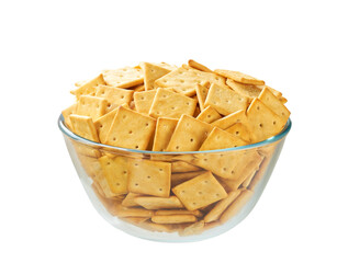 Square crackers in a clear glass bowl isolated on white background.