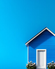 A charming blue house with a white door and blooming flowers, set against a vibrant blue backdrop,...