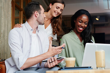 Coffee shop, laptop and business people in meeting for remote work, online project and networking. Cafeteria, restaurant and men and women in discussion on computer for planning, research and website