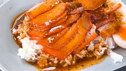 Red pork and crispy pork on rice, food in Thailand.
