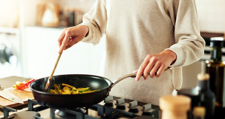 Hands, frying pan and cooking as woman in kitchen for diet, recipe and ingredients in home. Person,...