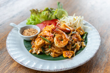 Fried noodle Thai style with prawns or Pad Thai, famous traditional Thai food street food in Thailand.