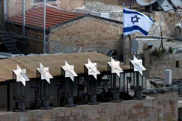 Holocaust memorial and Israeli flag above the Western Wall in the Old City of Jerusalem.