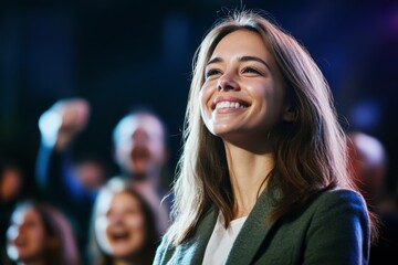 smiling female politician with supportive crowd cheering in background, celebrating public engagement and leadership at campaign event
