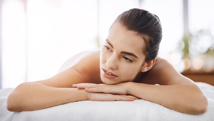 Fototapeta premium Relax, massage and thinking with woman at spa for skincare therapy, zen and beauty treatment. Detox, holistic healing and salon with person at hotel resort for cosmetics, wellness center and pamper