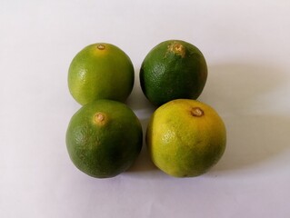 4 limes on a white background