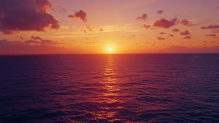 Obraz premium Sunset over calm ocean, sky ablaze with vibrant oranges and purples