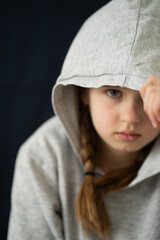 A young girl trying to close herself off from the outside world, capturing themes of isolation,...