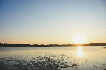 Fototapeta premium Sunset water surface and shadows of trees