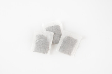 Three tea bags are sitting on a white background