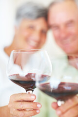 Mature couple, hands and red wine with glass for alcohol tasting, celebration or date together at home. Closeup, elderly man and woman with drink or alcoholic beverage for holiday or bonding at house
