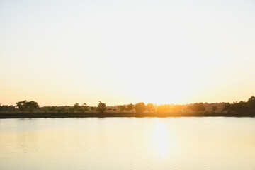 Fototapeta premium Sunset water surface and shadows of trees
