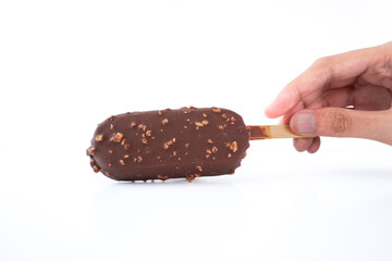 A hand holding a green and white ice cream stick