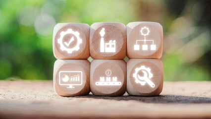 Wooden blocks with icons symbolizing a manufacturing execution system, showcasing industry 4.0, automation, and production management concepts.