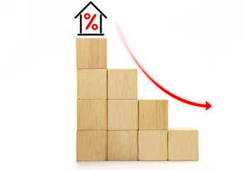 House interest rate with decrease percentage and down arrow icon on wooden blocks cube. Real estate property investment and house loan concept.