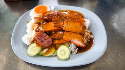 Red pork and crispy pork on rice, food in Thailand.