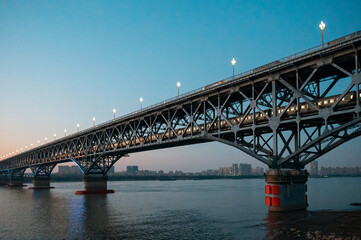 A train travels on the Yangtze River Bridge in Nanjing, China in the evening