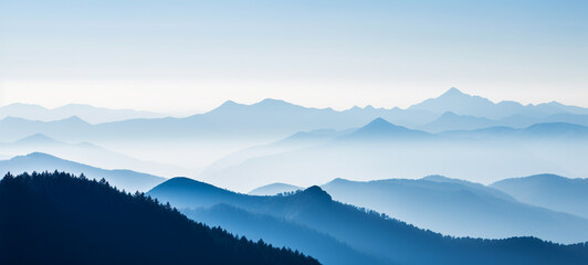 Majestic mountain landscape with cascading hills shrouded in misty hazy atmosphere creating a serene tranquil and ethereal outdoor scene  Beautiful panoramic vista of the natural environment
