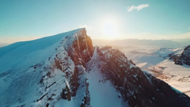 A quick flight over a mountain range with snow or mountain peaks with a beautiful sunset in the background
