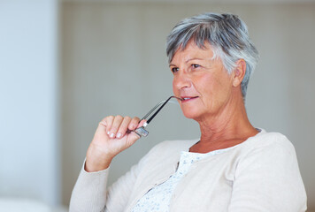 Senior woman, thinking and glasses in home, morning reflection and remember memory in lounge....
