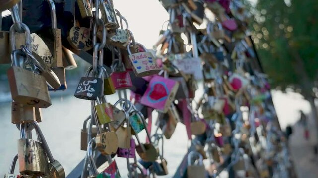 Closeup shot of the love Padlocks on the Bridge of the Seine River at Sunset in Paris, France