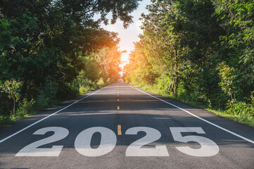 New year 2025, Text 2025 written on the road in the middle of asphalt road at sunset. Concept of planning, opportunity, hope, business strategy, new life change.
