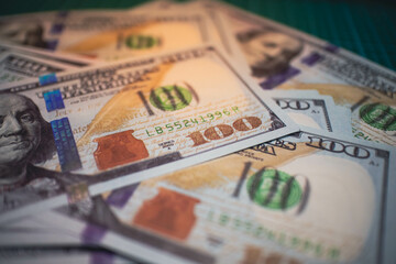 Green US dollar bills close up on a grid background, symbolizing currency, wealth, and financial transactions, perfect for themes related to banking, economy, and personal finance.
