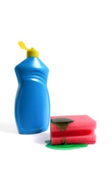 A bottle of dishwashing liquid with a sponge lies on a white background.