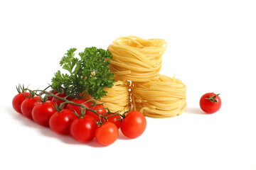 Round pasta nests with vegetables lie on white background.