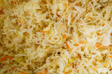 Vegetable salad. Shredded cabbage and carrots closeup background. Homemade sauerkraut - fermented cabbage and carrots. healthy food of background