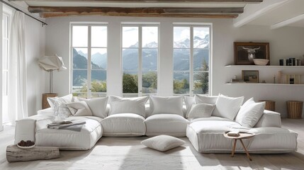 Fototapeta premium A white sectional sofa sits in a large, bright living room with a view of mountains and a lake outside the windows.
