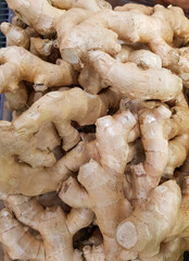 Fresh organic ginger on the fresh food market, vertical background