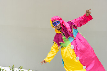 Person in Vibrant Harlequin Carnival Costume Striking a Playful Pose