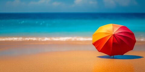 A vibrant umbrella stands alone on a pristine beach, casting a vivid contrast against the azure sea and golden sand.