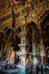 Fototapeta premium Stone statue of cross-legged Bodhisattva in Cave 18 of Yungang Grottoes, Datong, Shanxi Province