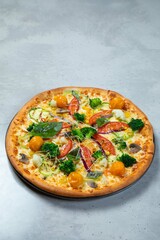 Delicious vegetarian pizza lying on gray table background