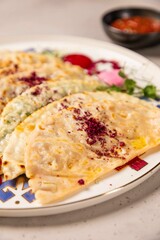 Delicious qutab being served on a plate with sumac spice