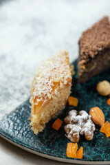 Delicious baklava piece covered in coconut flakes laying on a plate