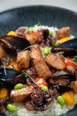 Delicious seafood risotto with mussels and octopus in a bowl