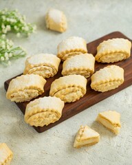 Cottage cheese cookies, russian pastry sochniki laying on wooden board