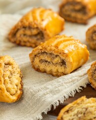 Rugelach with poppy seeds filling lying on linen cloth