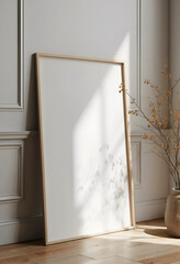 A wooden frame leaning against the wall in soft natural light, with dried flowers nearby, ideal for minimalist decor or mockup purposes.