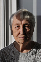 Head shot close up portrait thoughtful middle aged retired woman worrying about personal health problems. Upset older female retiree thinking of family troubles, feeling lonely, sitting at home.