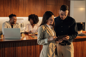 Businesspeople with tablet working on renewable energy research at office