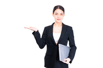 Professional businesswoman in a suit, confidently presenting with open hand gesture. She holds laptop computer exuding sense of leadership and business acumen, set against white background