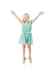 Studio, smile and girl in portrait for jump, hands up and fashion dress for first day of kindergarten. Space, child and development with flying game for playing, energetic and white background