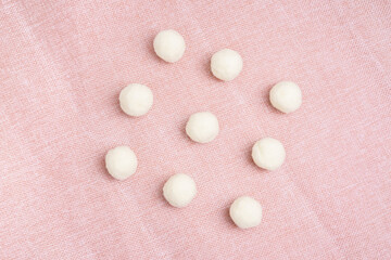 White fur ball on pink jute fabric for baby girl decoration